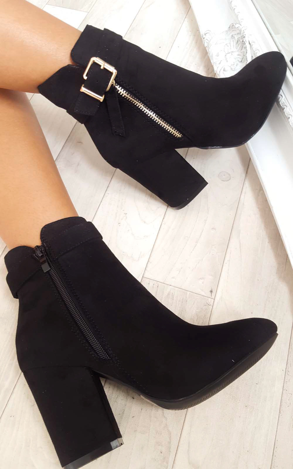 black ankle boots with gold buckles